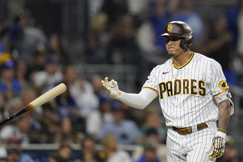 San Diego Padres' Manny Machado tosses his bat after striking out during the third inning of the team's baseball game against the Los Angeles Dodgers, Wednesday, Aug. 25, 2021, in San Diego. (AP Photo/Gregory Bull)