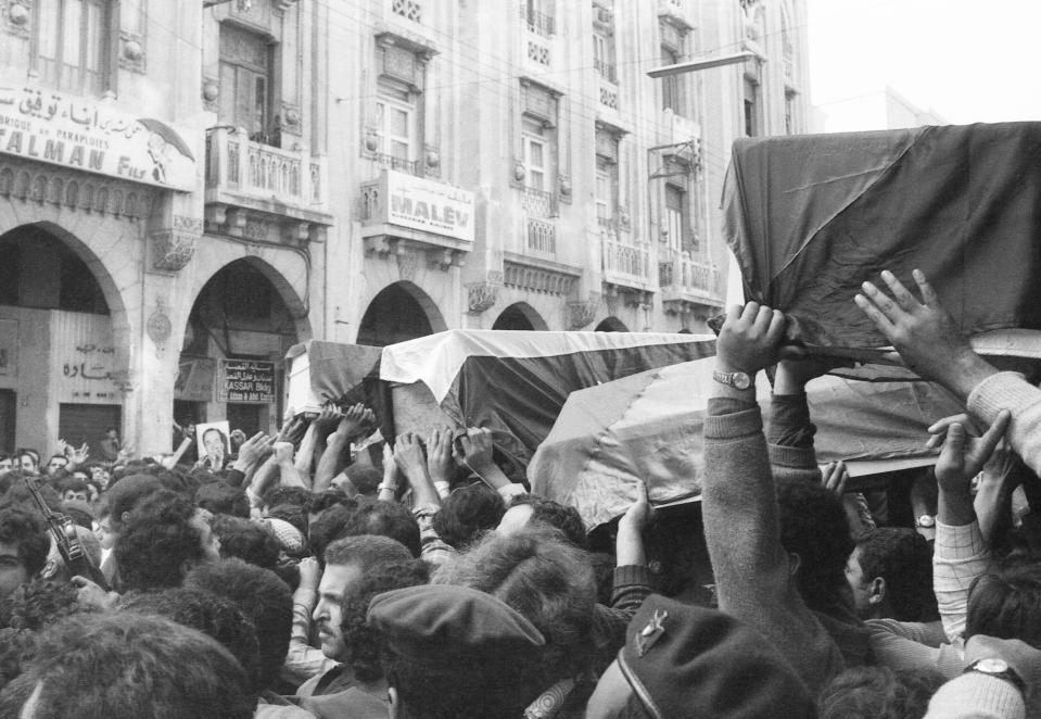 FILE - Flag draped coffins of slain Palestinians killed in Israeli raid are taken through the streets of Beirut, Lebanon on April 12, 1973, during the funeral procession. The Israeli commando force led by a man disguised as brunette, Ehud Barak, who later rose to become Israel's prime minister infiltrated a posh Beirut neighborhood shooting dead three top officials with the Palestine Liberation Organization in two separate adjacent buildings. (AP Photo, File)