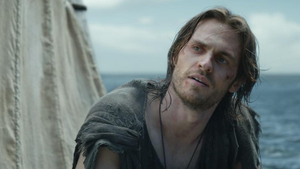 Charlie Vickers as Halbrand on The Lord of the Rings floating on his wreckage at sea