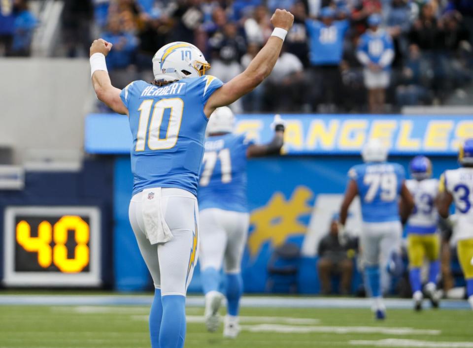 Chargers quarterback Justin Herbert celebrates a touchdown run by running back Austin Ekeler in January.