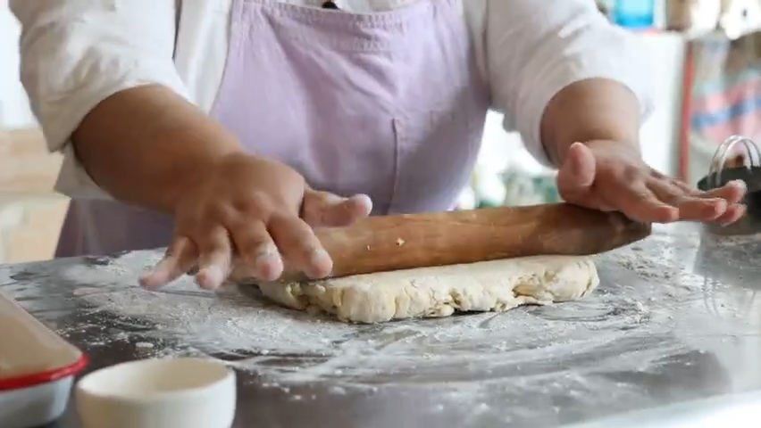 Cheryl Day, owner of Back in the Day Bakery, teaches Josephine Johnson how to make flakey, layered biscuits.