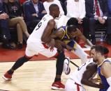 Golden State Warriors forward Kevin Durant #35 injures his leg in this play against Toronto Raptors' Serge Ibaka #9 during the first half of the NBA Finals basketball Game 5 between the Golden State Warriors and the Toronto Raptors at Scotiabank Arena in Toronto. (Photo by EPA/LARRY W. SMITH)