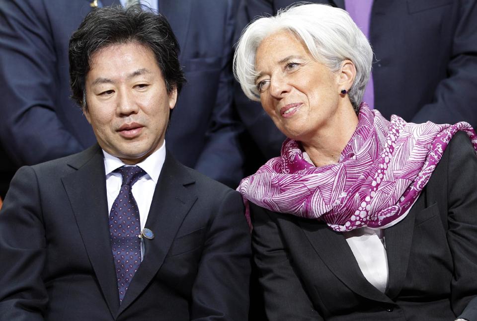 International Monetary Fund Managing Director Christine Lagarde speaks with speaks with Japan's Finance Minister Jun Azumi during a group photo of the International Monetary and Financial Committee of the IMF/World Bank spring meetings in Washington Saturday, April, 21, 2012. (AP Photo/Jose Luis Magana)