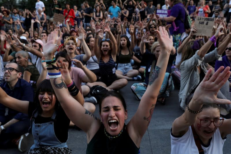 FILE PHOTO: Protesters do a sit down in front of the Spanish Parliament during a demonstration against the release on bail of five men known as the "Wolf Pack" cleared of a gang rape of a teenager and convicted of a lesser crime of sexual abuse in Madrid