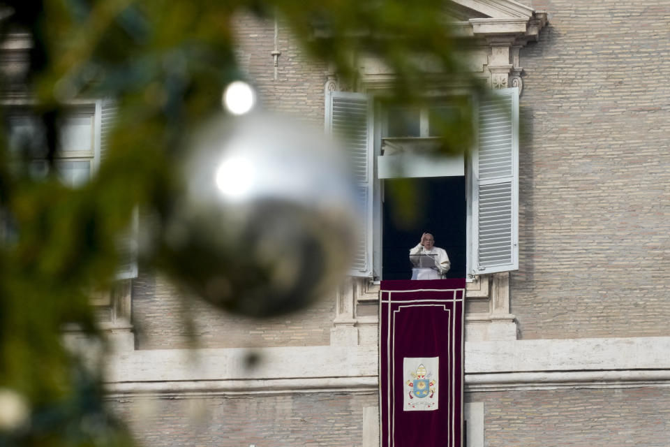 Pope Francis delivers his blessing as he recites the Angelus noon prayer from the window of his studio overlooking St. Peter's Square, at the Vatican, Sunday, Dec. 31, 2023. (AP Photo/Andrew Medichini)