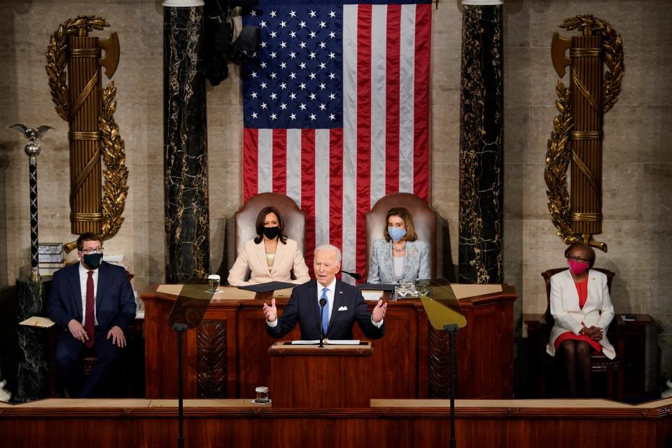 President Joe Biden addresses a joint session of Congress as Vice President Kamala Harris (L) and House Speaker Nancy Pelosi (R) look on in the House chamber of the U.S. Capitol April 28, 2021, in Washington, D.C.