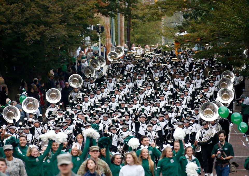 The Marching 110 members march down College Street at Ohio University's homecoming parade in Athens, Ohio on Saturday, Oct. 12, 2019.