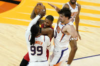 Portland Trail Blazers guard Damian Lillard is pressured by Phoenix Suns forward Jae Crowder (99) and forward Dario Saric, right, during the second half of an NBA basketball game, Thursday, May 13, 2021, in Phoenix. (AP Photo/Matt York)