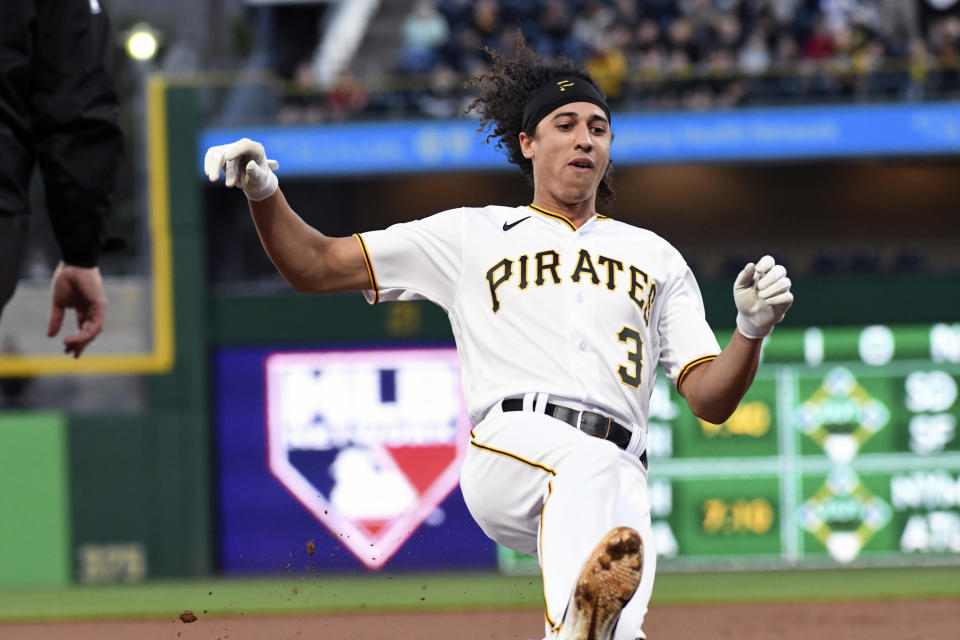 Pittsburgh Pirates' Cole Tucker (3) slides safely into third base in the first inning during a baseball game against the Cincinnati Reds in Pittsburgh, Friday, Oct. 1, 2021. Turner scored later in the inning. (AP Photo/Philip G. Pavely)