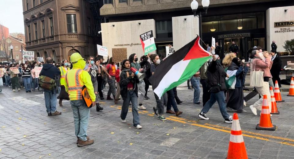 Palestine supporters rally outside the Textron headquarters in Providence on Friday.