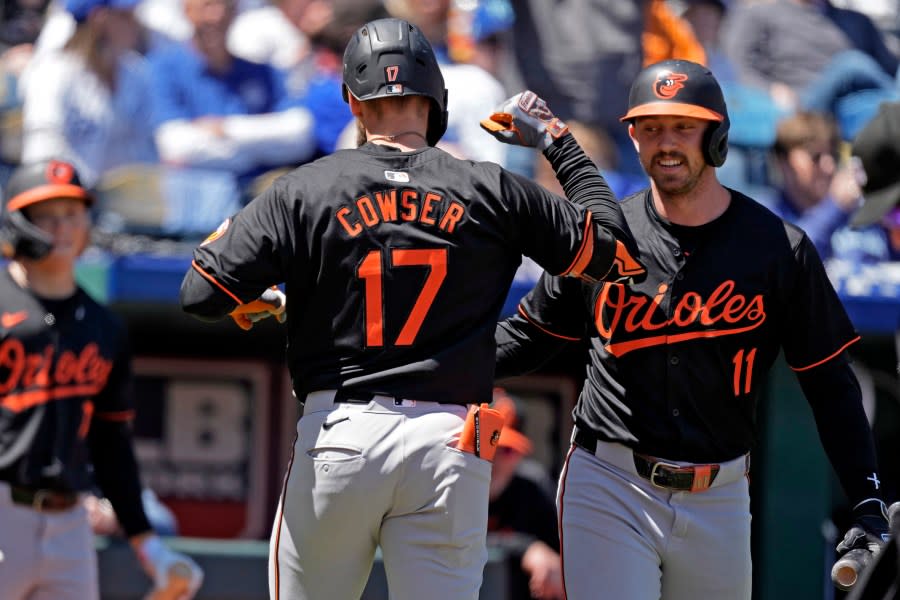 Baltimore Orioles’ Jordan Westburg (11) celebrates with Colton Cowser (17) after Cowser hit a solo home run during the third inning of a baseball game against the Kansas City Royals Sunday, April 21, 2024, in Kansas City, Mo. (AP Photo/Charlie Riedel)