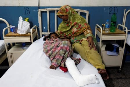 Eight-year-old Halima Sadia, who was injured after a wall fell on her during an earthquake, is being taken care by her grandmother at the Divisional Headquarters Teaching Hospital Mirpur
