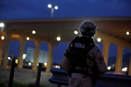 A member of the Mexican National Guard keeps watch near the border between Mexico and U.S.