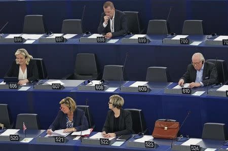 France's far-right National Front political party leader and member of the European Parliament Marine Le Pen (Second row,L) and her father, party founder and honorary president Jean-Marie Le Pen (Second row,R) wait for the start of a voting session at the European Parliament in Strasbourg, France, May 19, 2015. REUTERS/Vincent Kessler