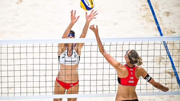 American Alix Klineman, left, was dominant at the net in the second and final set Sunday, partnering with April Ross for a 21-16, 21-15 sweep of Canadians Sarah Pavan, right, and Melissa Humana-Paredes in a bronze-medal match in Cancun, Mexico. (Submitted by FIVB - image credit)