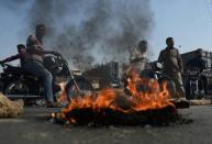 Supporters of Tehreek-e-Labaik Pakistan, a hardline religious political party, block the road during a protest against the court decision to overturn the blasphemy conviction of Christian woman Asia Bibi, in Karachi