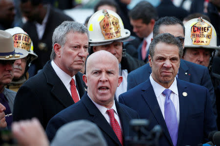 New York City mayor Bill de Blasio and New York State Governor Andrew Cuomo look on as New York City Police Commissioner James O'Neill speaks during a news conference outside the New York Port Authority Bus Terminal following reports of an explosion, in New York City, U.S. December 11, 2017. At left is New York City Mayor Bill de Blasio. REUTERS/Brendan McDermid