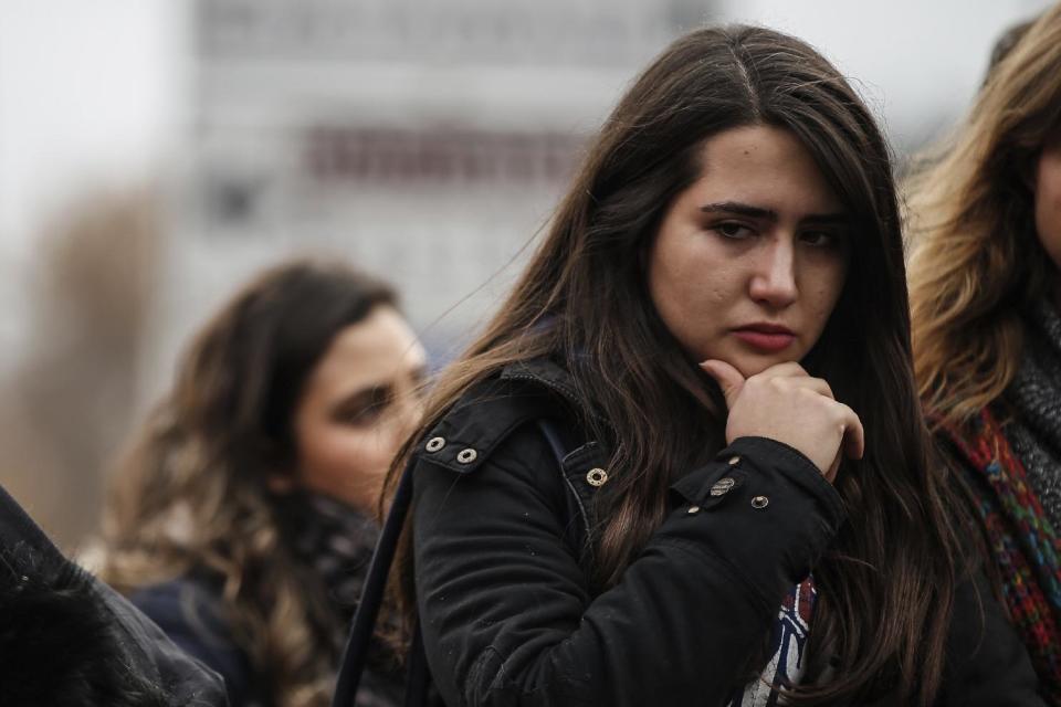 People mourn victims outside the Besiktas football club stadium Vodafone Arena in Istanbul, Monday, Dec. 12, 2016. Turkey launched a full investigation and bury the dead Monday after two bombings in Istanbul killed dozens of people and wounded score others near Besiktas' stadium. Turkish authorities have banned distribution of images relating to the Istanbul explosions within Turkey.(AP Photo/Emrah Gurel)