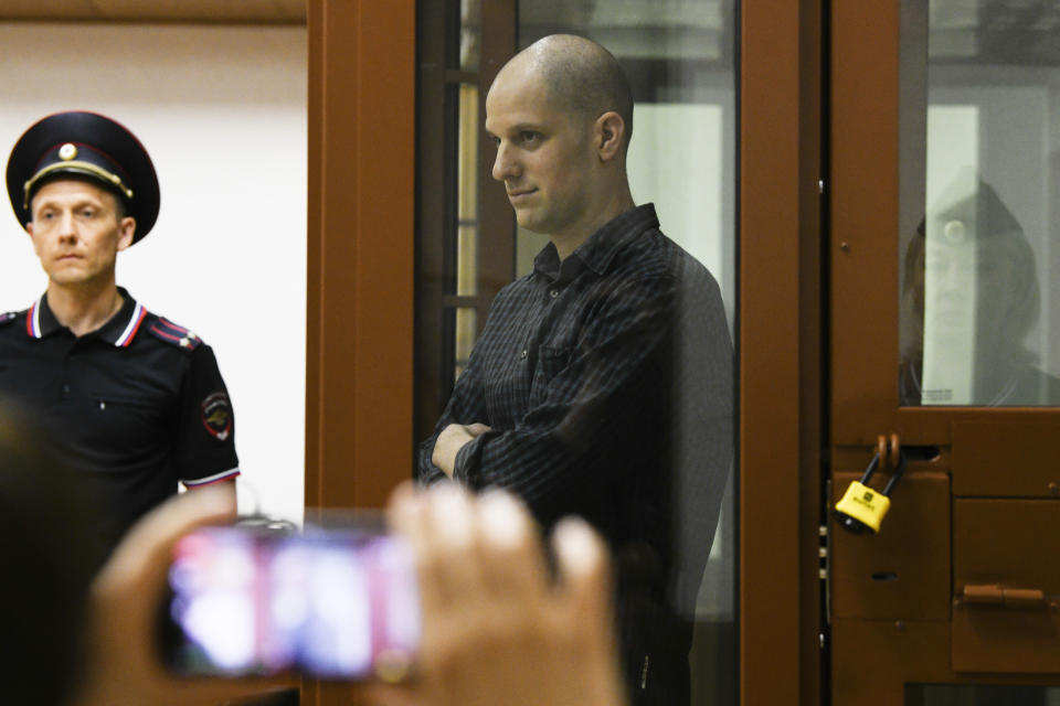 Wall Street Journal reporter Evan Gershkovich, center, stands in a glass cage in a courtroom in Yekaterinburg, Russia, Wednesday, June 26, 2024. Fifteen months after he was arrested in the city of Yekaterinburg on espionage charges, Gershkovich returns there for his trial starting Wednesday, June 26, 2024, behind closed doors. Gershkovich, his employer and the U.S. government deny the charges. (AP Photo)