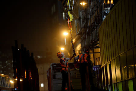 Construction continues into the night in the City of London, Britain October 18, 2017. Picture taken October 18, 2017. REUTERS/Mary Turner