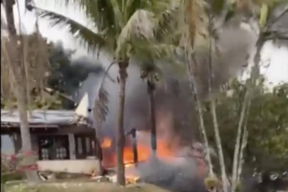 This frame grab from video shows fire coming from a plane that crashed by a home in Vinhedo, Sao Paulo state, Brazil, Friday, Aug. 9, 2024. (Felipe Magalhaes Filho via AP)