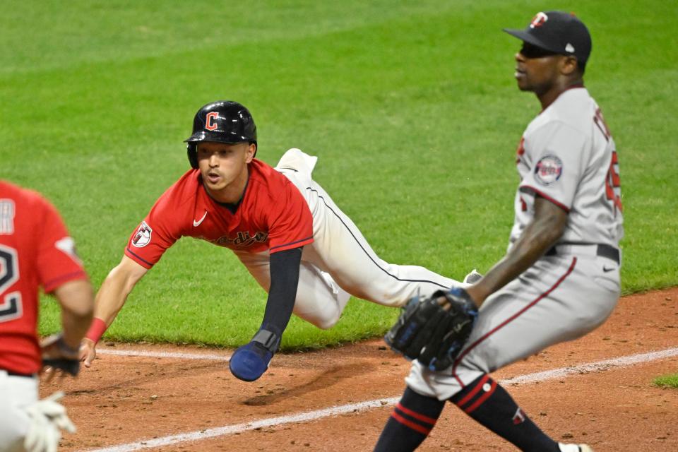 Guardians left fielder Steven Kwan scores on a passed ball beside Minnesota Twins relief pitcher Jharel Cotton in the 10th inning Wednesday, June 29, 2022, in Cleveland.