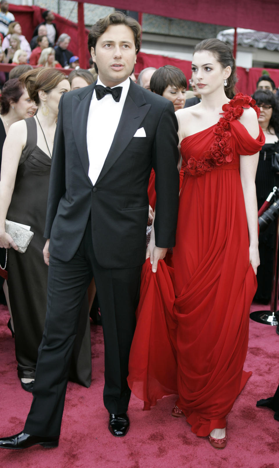 In this Feb. 24, 2008 file photo, actress Anne Hathaway, right, walks the red carpet with her then-boyfriend Raffaello Follieri, at the Kodak Theater for the 80th Academy Awards in Los Angeles. Follieri was released Friday morning from a prison in Loretto, 80 miles east of Pittsburgh. Follieri pleaded guilty to cheating investors by falsely claiming he had Vatican connections that enabled him to buy church property at a discount. He was sentenced in 2008 to 4 1/2 years in prison. Follieri agrees he owes more than $3.6 million to those he ripped off. The proceeds supported a playboy lifestyle that included a $37,000-a-month New York City apartment and lavish vacations with the star of "The Princess Diaries." (AP Photo/Amy Sancetta, file)