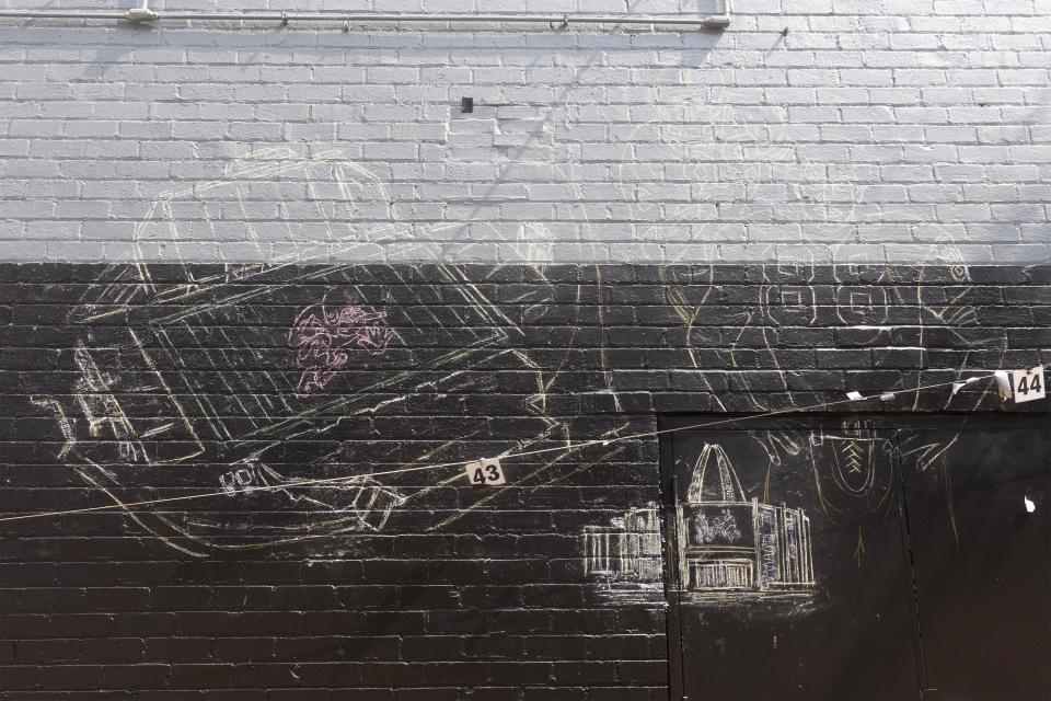 A sketching for a new mural has appeared on the side of the former Buzzbin building where the Greetings from Canton postcard-style mural had been.