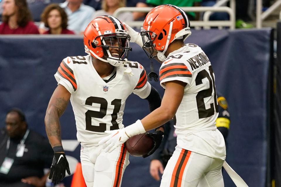 Cleveland Browns cornerback Denzel Ward (21) is congratulated by Greg Newsome II (20) after Ward recovered a Texan fumble to score during the second half of an NFL football game between the Cleveland Browns and Houston Texans in Houston, Sunday, Dec. 4, 2022. (AP Photo/Eric Christian Smith)