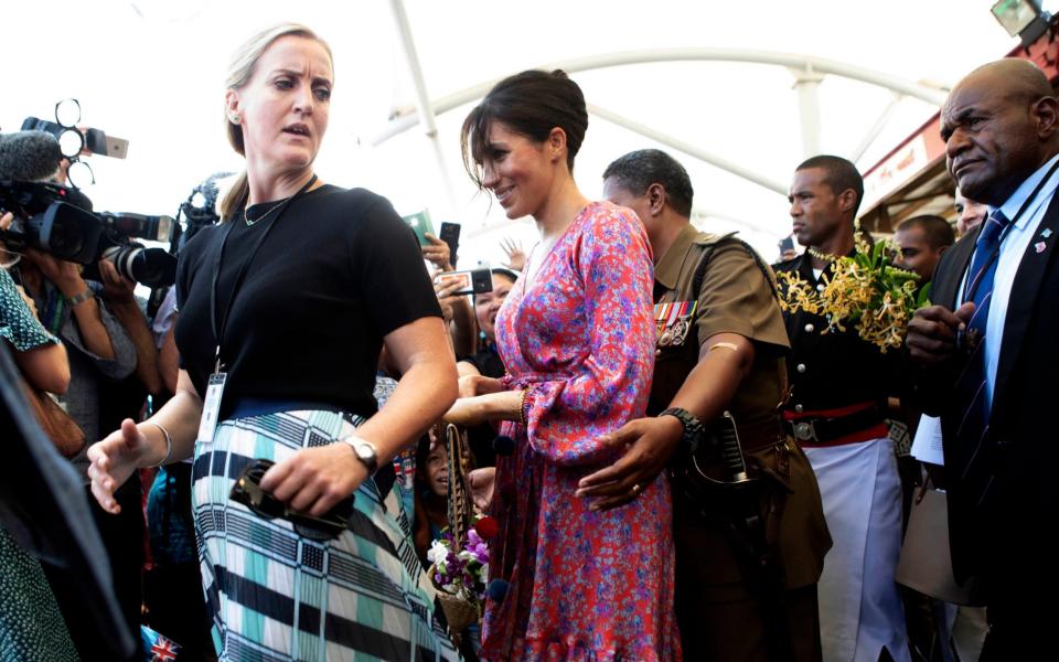 The Duchess of Sussex is escorted through a market in Suva, Fiji - Ian Vogler /PA