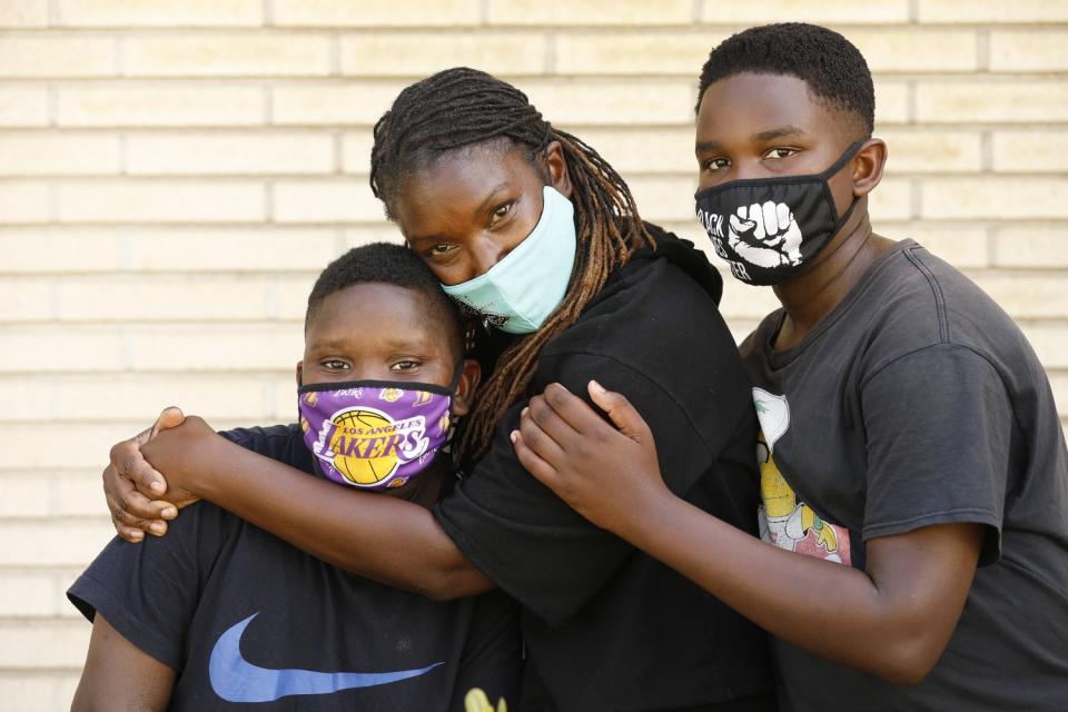 Nurse Valerie Udeozor with her sons Glory, 14, and Sunny, 12.