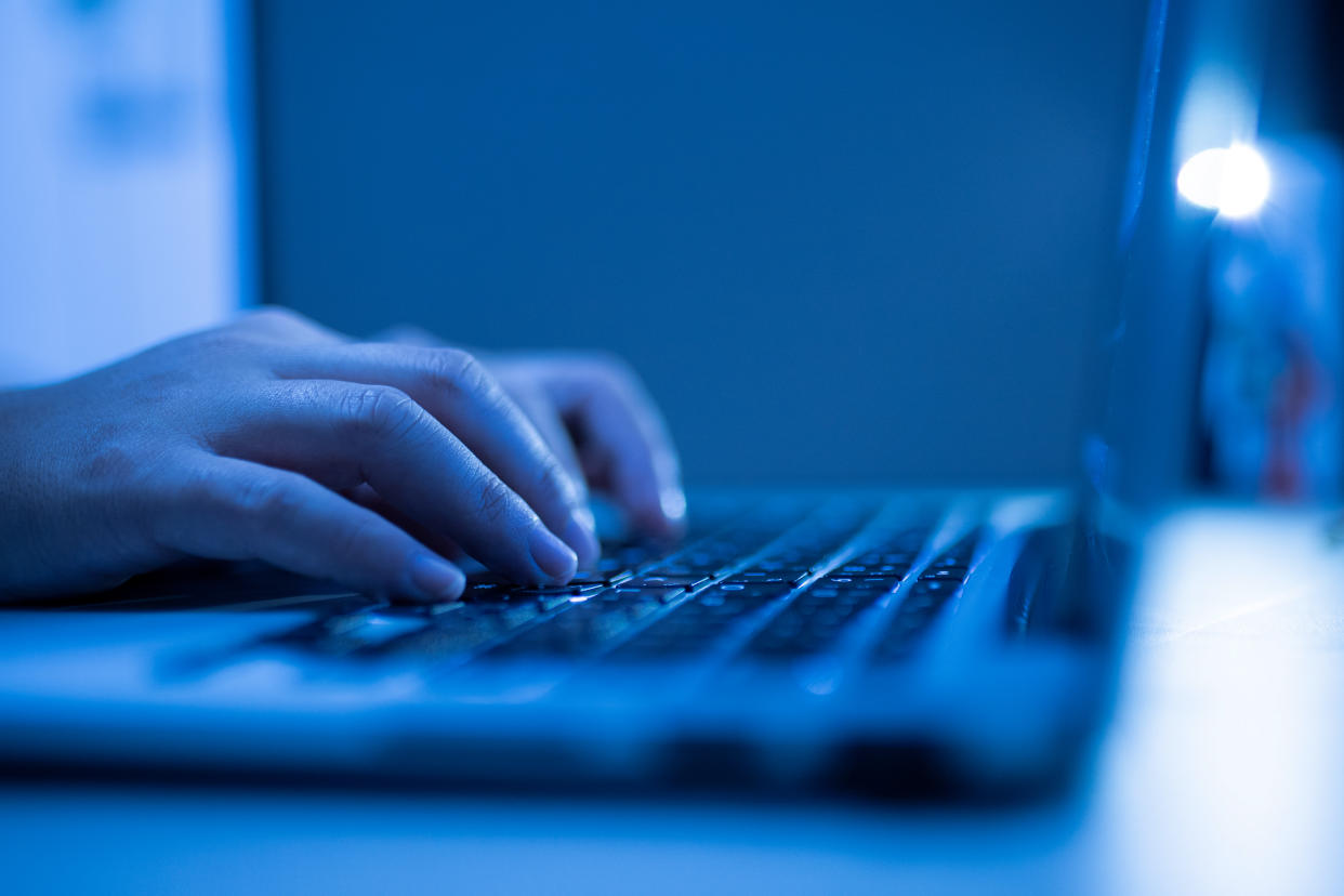 Hand of a man using laptop computer for hacking or steal data at night in office. (Getty Images file photo)