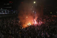 Israelis opposed to Prime Minister Benjamin Netanyahu's judicial overhaul plan set up bonfires and block a highway during a protest moments after the Israeli leader fired his defense minister, in Tel Aviv, Israel, Sunday, March 26, 2023. Defense Minister Yoav Gallant had called on Netanyahu to freeze the plan, citing deep divisions in the country and turmoil in the military. (AP Photo/Oren Ziv)