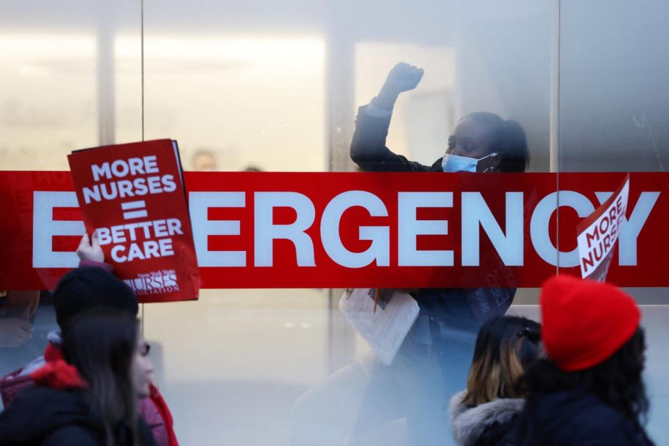 A hospital worker raises a fist as NYSNA nurses walk off the job, to go on strike at Mount Sinai Hospital in New York City, U.S. January 9, 2023 (REUTERS)