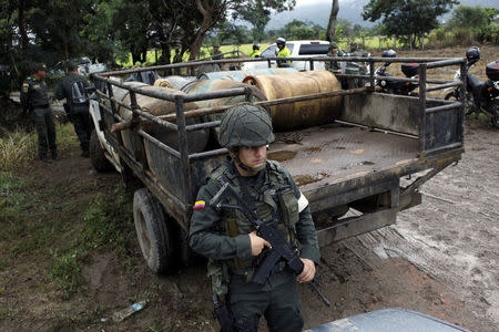 A Colombian soldier stands guard in front of a truck loaded with containers of gasoline seized during a military operation at the border with Venezuela in Cucuta, Colombia February 13, 2018. REUTERS/Carlos Eduardo Ramirez