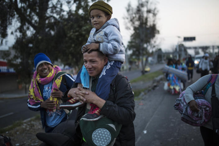 Central American migrants, part of the caravan hoping to reach the U.S. border, walk while leaving a temporary shelter early in the morning in Queretaro, Mexico, Sunday, Nov. 11, 2018. Local Mexican officials were once again Sunday helping thousands of Central American migrants find rides on the next leg of their journey toward the U.S. border. (AP Photo/Rodrigo Abd)