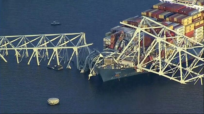 Parts of the Francis Scott Key Bridge remain after a container ship collided with one of the bridge's supports Tuesday, March 26, 2024 in Baltimore. The major bridge in Baltimore snapped and collapsed after a container ship rammed into it early Tuesday, and several vehicles fell into the river below. Rescuers were searching for multiple people in the water. (WJLA via AP)