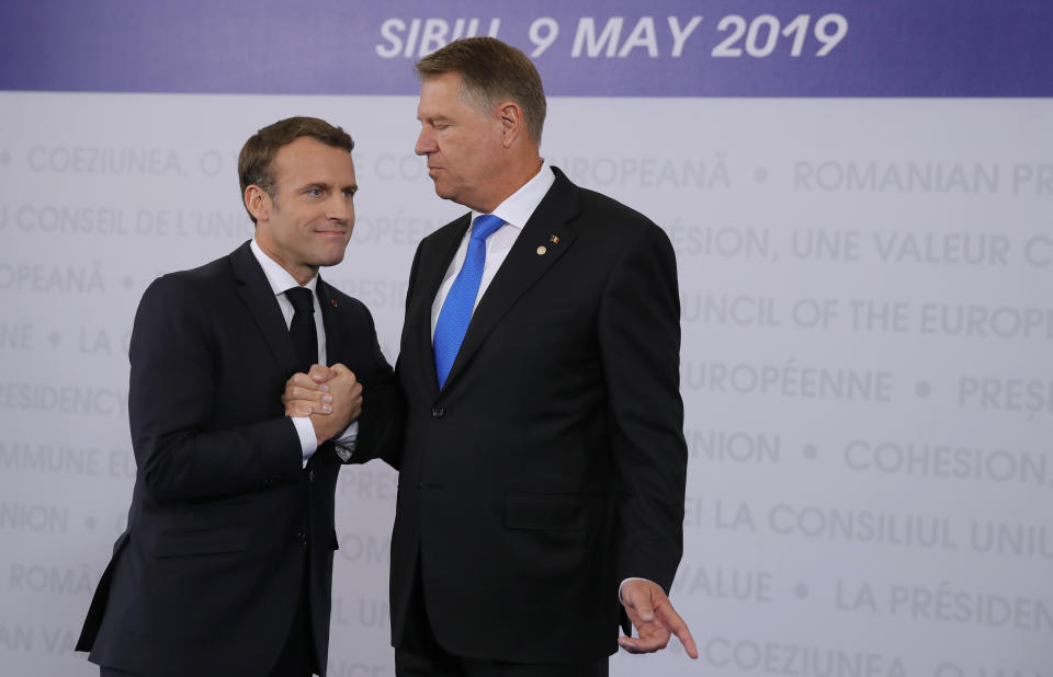 French President Emmanuel Macron, left, is welcomed by Romanian President Klaus Werner Ioannis as he arrives for an EU summit in Sibiu, Romania, Thursday, May 9, 2019. European Union leaders on Thursday start to set out a course for increased political cooperation in the wake of the impending departure of the United Kingdom from the bloc. (AP Photo/Vadim Ghirda)