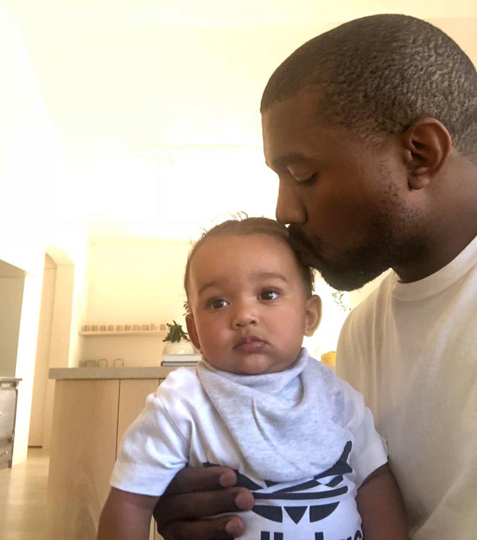 Chi gets a kiss from her dad, who <a href="https://people.com/music/kanye-west-moving-back-chicago-new-music/" rel="nofollow noopener" target="_blank" data-ylk="slk:named her after his hometown;elm:context_link;itc:0;sec:content-canvas" class="link ">named her after his hometown</a>. 