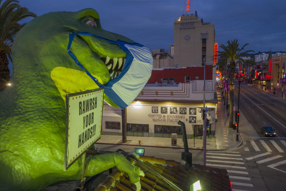 The dinosaur atop the Ripley's Believe It or Not! Odditorium wears a mask to encourage people to take safety measures as coronavirus infections spread on April 19, 2020.