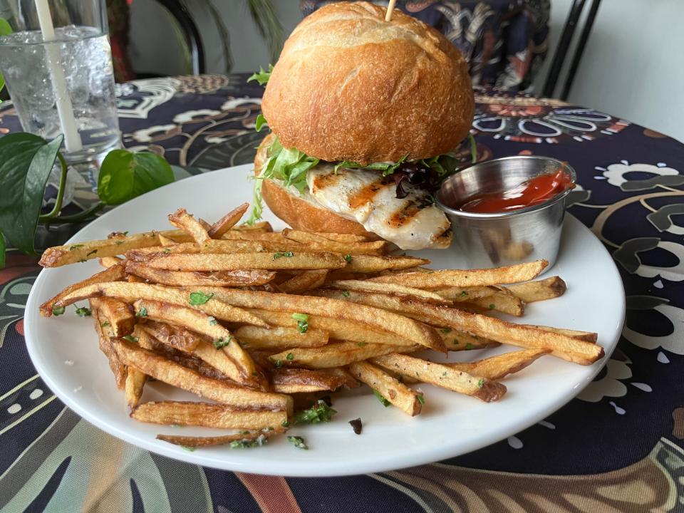 A Metro Parks Chicken Sandwich — which includes brined chicken breast, avocado, rosemary-dried cran aioli and greens on house-made bun — with a side of fries.