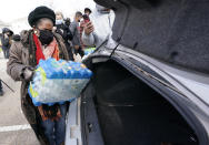 U.S. Rep. Sheila Jackson Lee, D-Texas, loads donated water into a car at a distribution site Thursday, Feb. 18, 2021, in Houston. Houston and several surrounding cities are under a boil water notice as many residents are still without running water in their homes. (AP Photo/David J. Phillip)