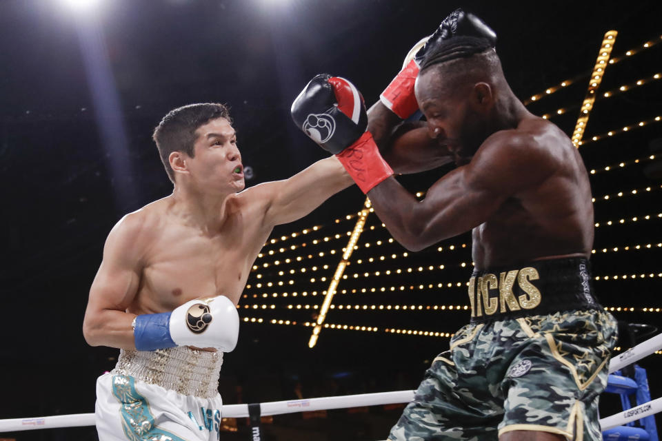 Kazakhstan's Daniyar Yeleussinov, left, punches Reshard Hicks during the first round of a featherweight boxing match Friday, Sept. 13, 2019, in New York. Yeleussinov stopped Hicks in the first round. (AP Photo/Frank Franklin II)