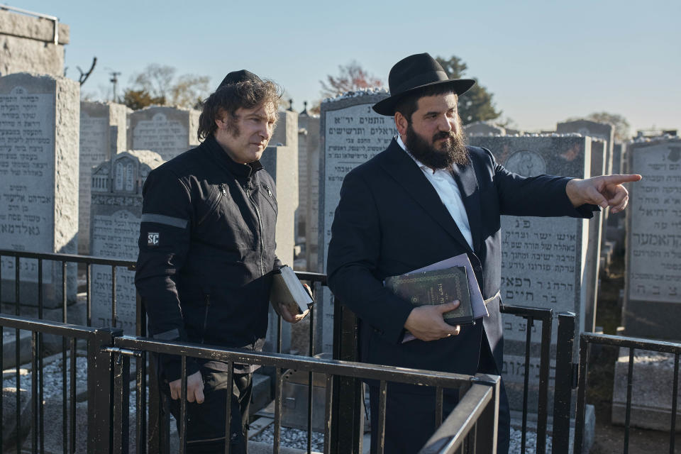 Argentina's President-elect, Javier Milei, left, visits the Montefiore Cemetery after praying next to Chabad-Lubavitch rabbis at the resting place of the Rebbe, Rabbi Menachem Mendel Schneerson on Monday, Nov. 27, 2023, in the Queens borough of New York. (AP Photo/Andres Kudacki)