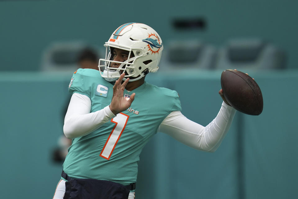 Miami Dolphins quarterback Tua Tagovailoa (1) passes during warm-ups ahead of an NFL football game against the Green Bay Packers, Sunday, Dec. 25, 2022, in Miami Gardens, Fla. (AP Photo/Jim Rassol)