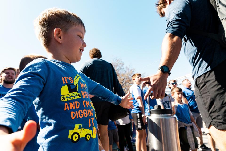 Henry Hartsock, 4, lines up to high-five Brigham Young University football players before their game against Southern Utah University at LaVell Edwards Stadium in Provo on Saturday, Sept. 9, 2023. | Megan Nielsen, Deseret News