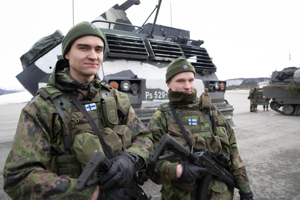 In this image provided by the North Atlantic Treaty Organization, Finnish soilders pose for a photo as NATO Secretary General Jens Stoltenberg visits during the Cold Response in Bardufoss, Norway, March 25, 2022. (NATO via AP)