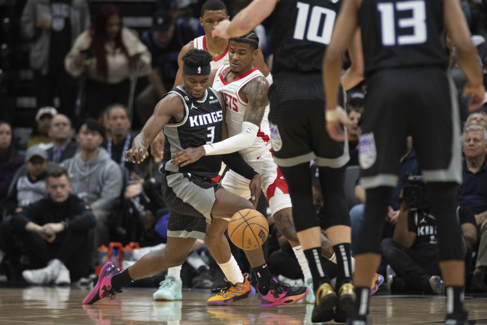 Houston Rockets guard Jalen Green knocks the ball away from Sacramento Kings guard Terence Davis (3) during the first quarter of an NBA basketball game in Sacramento, Calif., Friday, Jan. 13, 2023. (AP Photo/José Luis Villegas)