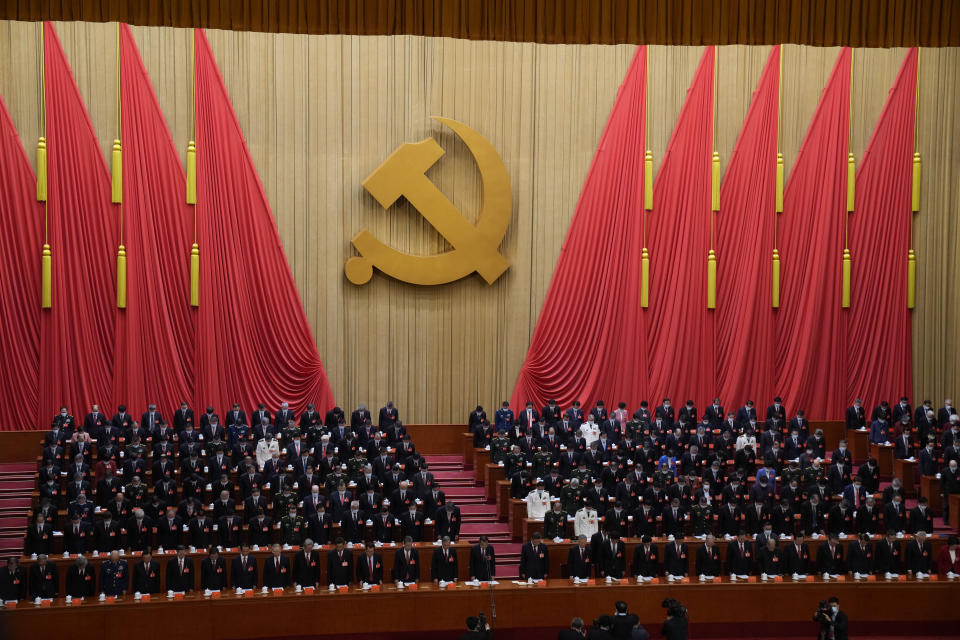 Attendees bow their heads to observe a moment of silence for fallen comrades during the opening ceremony of the 20th National Congress of China's ruling Communist Party held at the Great Hall of the People in Beijing, China, Sunday, Oct. 16, 2022. China on Sunday opens a twice-a-decade party conference at which leader Xi Jinping is expected to receive a third five-year term that breaks with recent precedent and establishes himself as arguably the most powerful Chinese politician since Mao Zedong. (AP Photo/Mark Schiefelbein)
