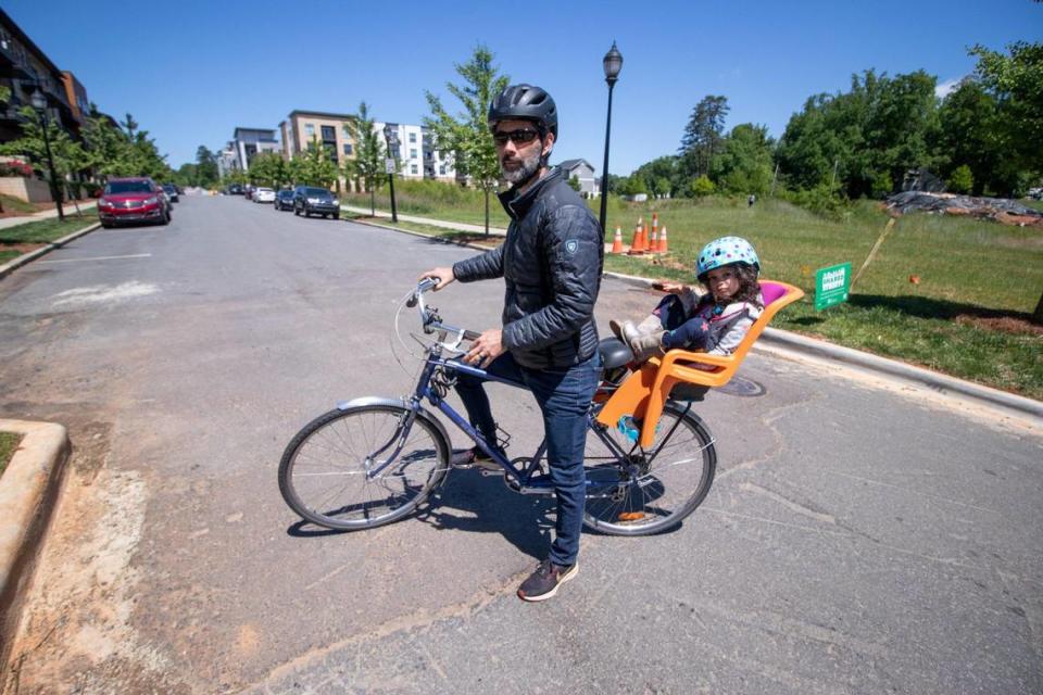 Sustain Charlotte founder and executive director Shannon Binns and his daughter Edie Moon Binns enjoy a leisurely ride on McClintock Road during Shared Streets.